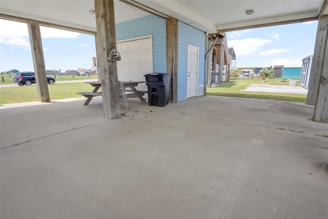 view of patio / terrace featuring a garage and a residential view