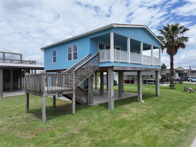 898 S Crystal Beach Rd, Crystal Beach, TX 77650 - rear view of house with a lawn, a wooden deck, stairway, and a patio