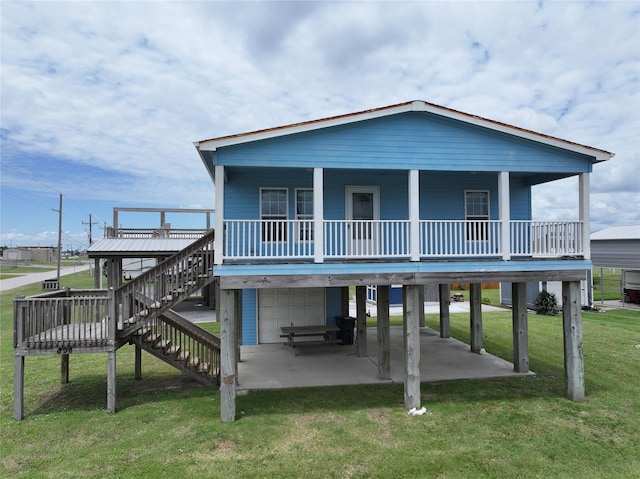 898 S Crystal Beach Rd, Crystal Beach, TX 77650 - rear view of property featuring stairway, a yard, a carport, a patio area, and a garage