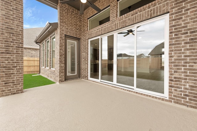 view of patio / terrace with a ceiling fan and fence
