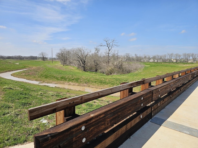 surrounding community featuring a yard and a rural view