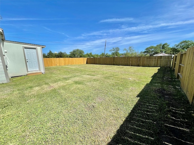 view of yard with a fenced backyard