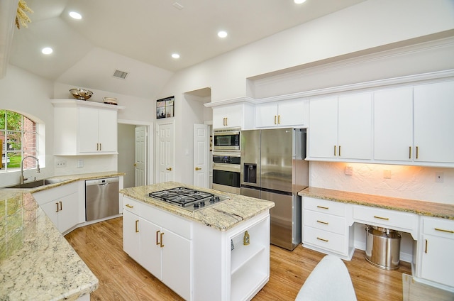 kitchen featuring decorative backsplash, a center island, open shelves, a sink, and stainless steel appliances