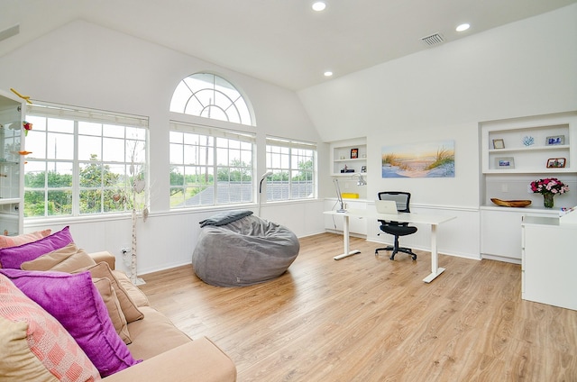 interior space featuring visible vents, built in features, vaulted ceiling, recessed lighting, and light wood-style flooring