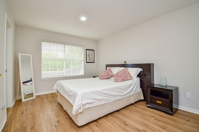 bedroom featuring baseboards, recessed lighting, and light wood-style flooring