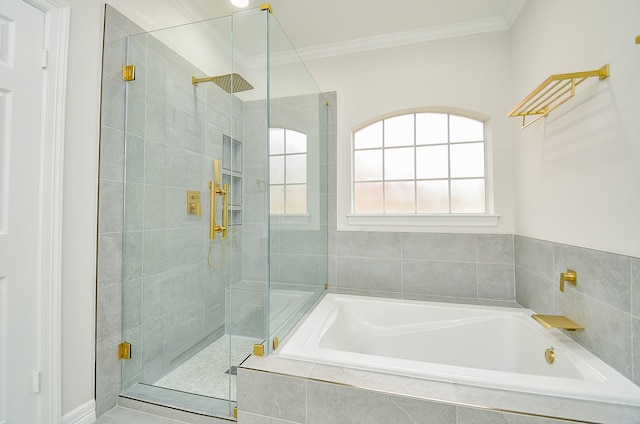 full bathroom featuring crown molding, a shower stall, and a garden tub