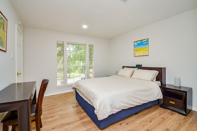 bedroom featuring recessed lighting, baseboards, and light wood-type flooring