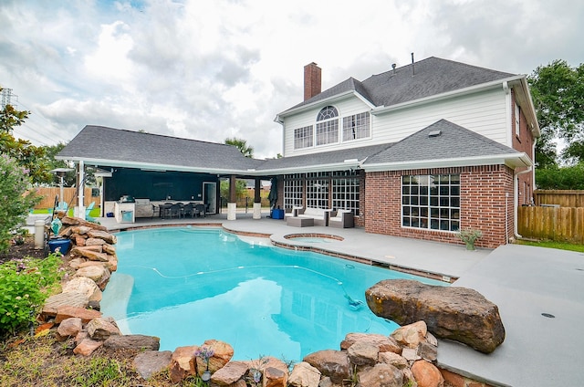 view of pool featuring fence, an in ground hot tub, an outdoor living space, and a patio area