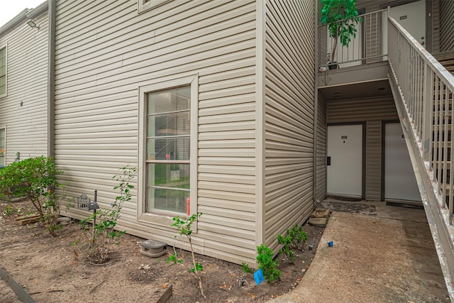view of exterior entry featuring a balcony