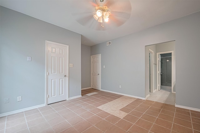 unfurnished bedroom featuring ceiling fan, baseboards, visible vents, and light tile patterned floors