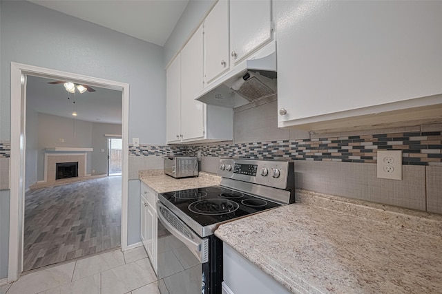 kitchen with stainless steel electric range oven, white cabinets, under cabinet range hood, and ceiling fan