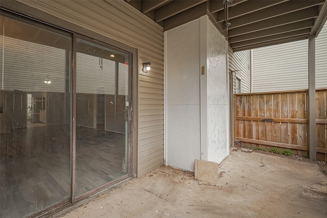 entrance to property with a patio and fence