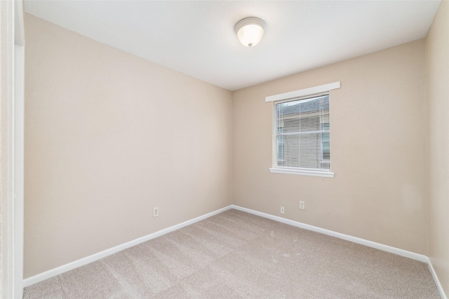 empty room with carpet floors and baseboards