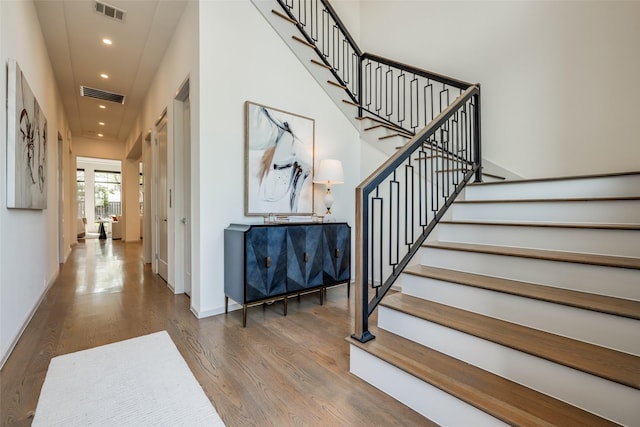 stairway with visible vents, recessed lighting, baseboards, and wood finished floors