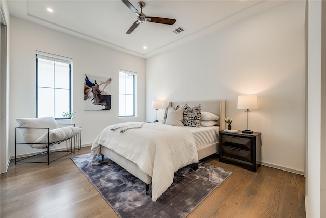 bedroom with recessed lighting, baseboards, a ceiling fan, wood finished floors, and visible vents