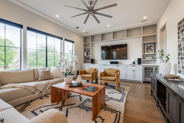 living area with ceiling fan, recessed lighting, beverage cooler, and wood finished floors