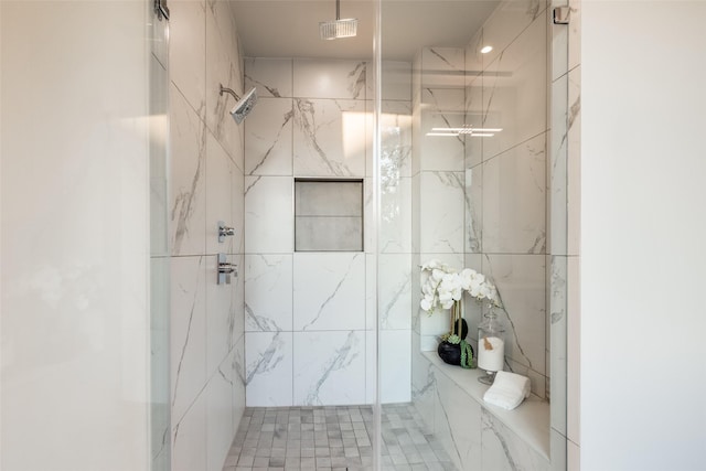 bathroom featuring visible vents and a marble finish shower