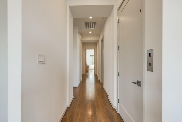 hall with recessed lighting, baseboards, visible vents, and wood finished floors