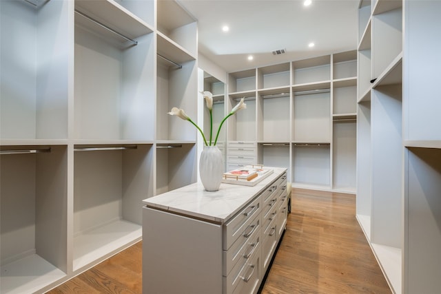 spacious closet featuring visible vents and wood finished floors