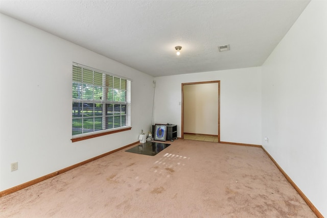 unfurnished living room featuring baseboards, carpet, and visible vents