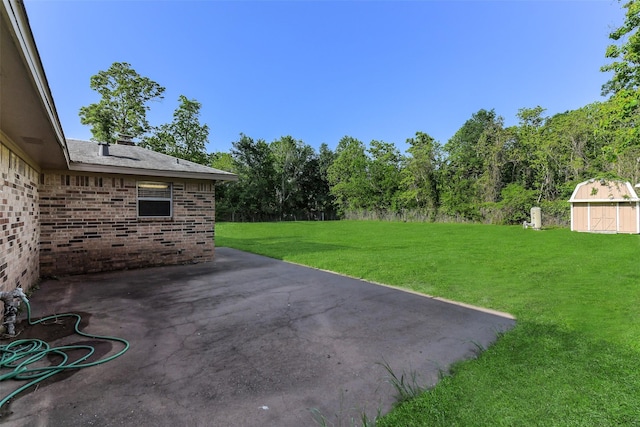 view of patio / terrace with an outdoor structure and a shed