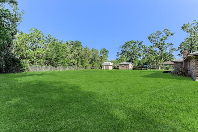 view of yard featuring a storage shed and an outbuilding