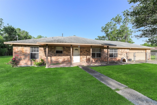 ranch-style house with brick siding, a garage, fence, and a front lawn