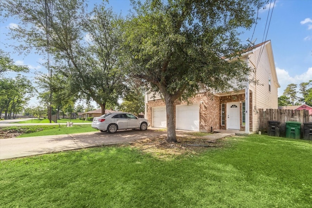 view of front facade featuring brick siding, fence, a front yard, and concrete driveway