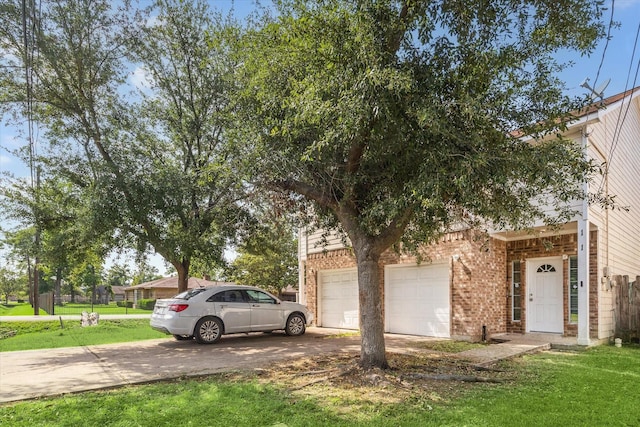 view of front of property with an attached garage, a front lawn, brick siding, and concrete driveway