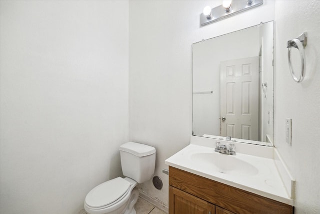 bathroom with tile patterned floors, vanity, and toilet