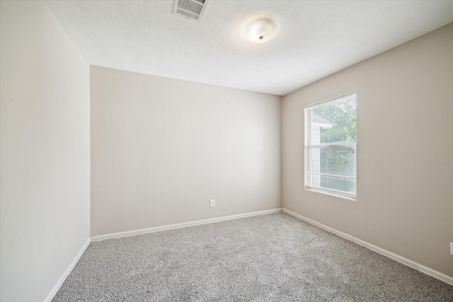 carpeted empty room with baseboards and visible vents