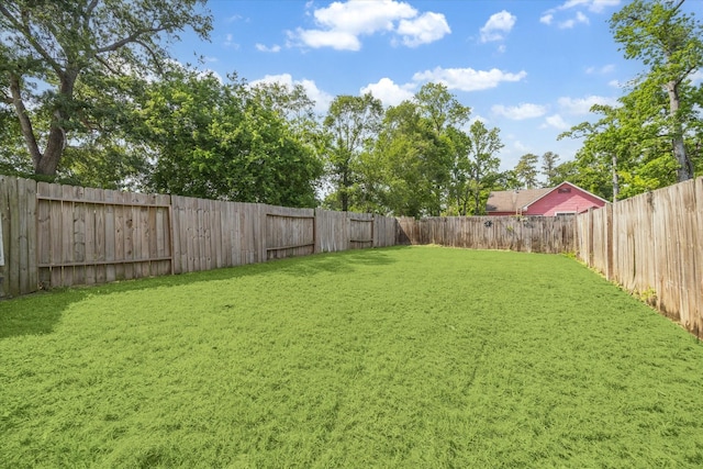 view of yard with a fenced backyard