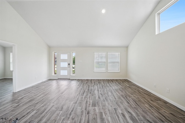 222 N Lynx Trl, Montgomery, TX 77316 - unfurnished living room featuring baseboards, wood finished floors, and a wealth of natural light