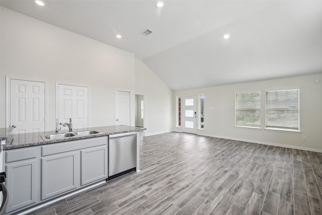 222 N Lynx Trl, Montgomery, TX 77316 - kitchen featuring visible vents, stainless steel dishwasher, a sink, high vaulted ceiling, and light wood finished floors