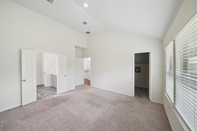 222 N Lynx Trl, Montgomery, TX 77316 - unfurnished bedroom with visible vents, carpet floors, baseboards, high vaulted ceiling, and a spacious closet
