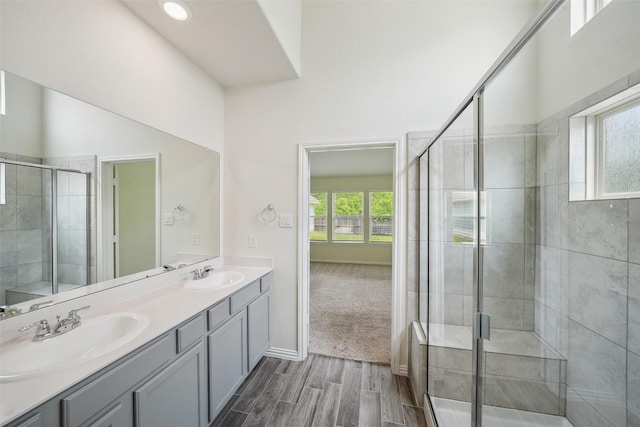 222 N Lynx Trl, Montgomery, TX 77316 - full bath with double vanity, a shower stall, a sink, and wood finished floors