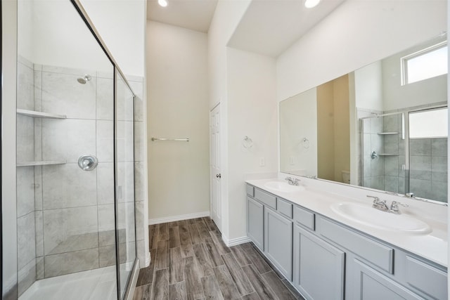 222 N Lynx Trl, Montgomery, TX 77316 - full bath featuring a sink, a shower stall, double vanity, and wood finished floors