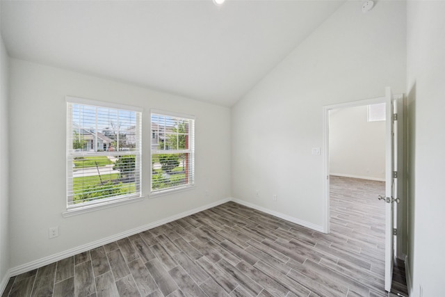 222 N Lynx Trl, Montgomery, TX 77316 - spare room featuring baseboards, vaulted ceiling, and light wood-type flooring