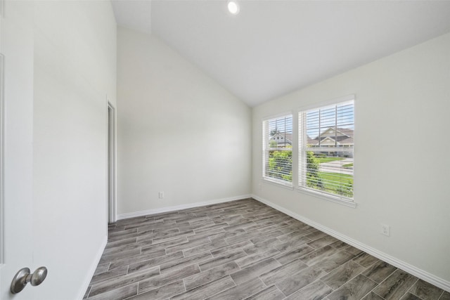 222 N Lynx Trl, Montgomery, TX 77316 - spare room with baseboards, vaulted ceiling, and wood finished floors
