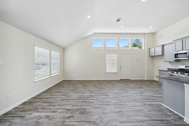 222 N Lynx Trl, Montgomery, TX 77316 - kitchen featuring stainless steel appliances, gray cabinetry, vaulted ceiling, light wood-type flooring, and visible vents