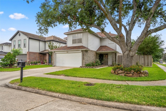 traditional home with fence, an attached garage, a front lawn, brick siding, and driveway