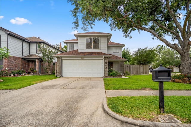 traditional-style home featuring a garage, brick siding, fence, a front lawn, and concrete driveway