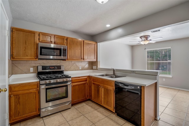kitchen with visible vents, a peninsula, appliances with stainless steel finishes, and light countertops