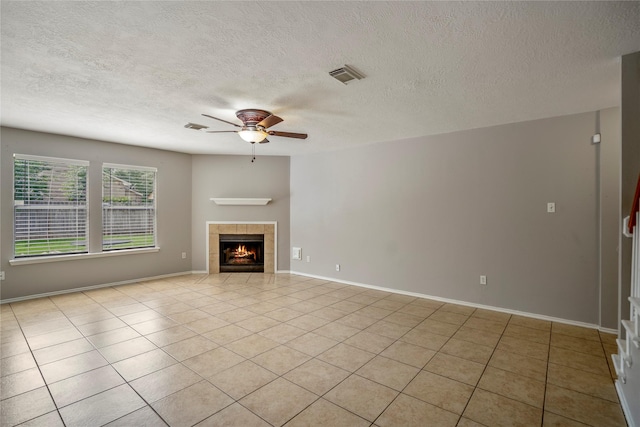 unfurnished living room with visible vents, a ceiling fan, and a textured ceiling