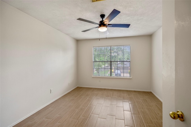 empty room with baseboards, a ceiling fan, and wood finished floors