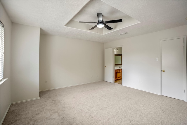 interior space featuring visible vents, a ceiling fan, a textured ceiling, and light carpet