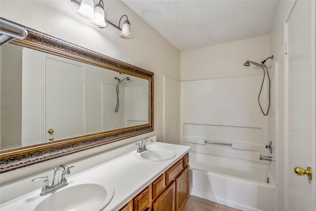 full bath featuring double vanity, a sink, washtub / shower combination, and tile patterned floors