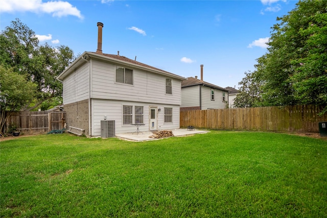 back of house with central air condition unit, a patio, a fenced backyard, and a lawn