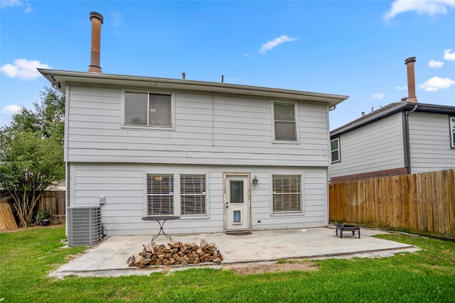 rear view of property featuring a patio, a fenced backyard, central air condition unit, and a yard