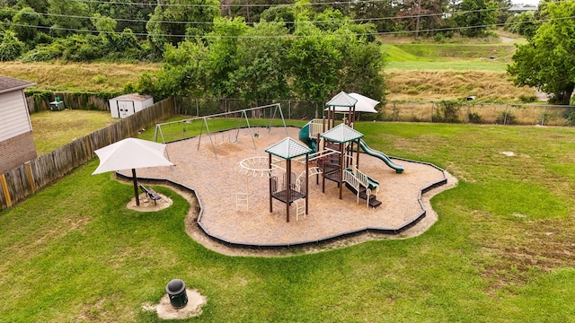 community play area with a fenced backyard and a yard
